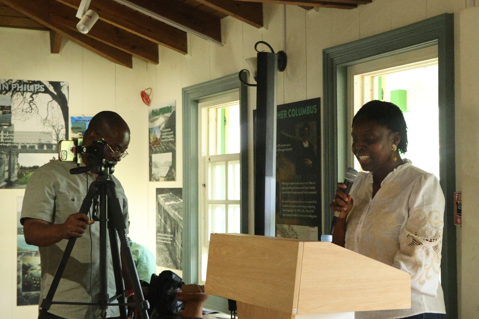 Dr. Nicole E. Francis Cotton making introductory remarks while Ambassador Jeffery Richardson of Interact Livestream looks on