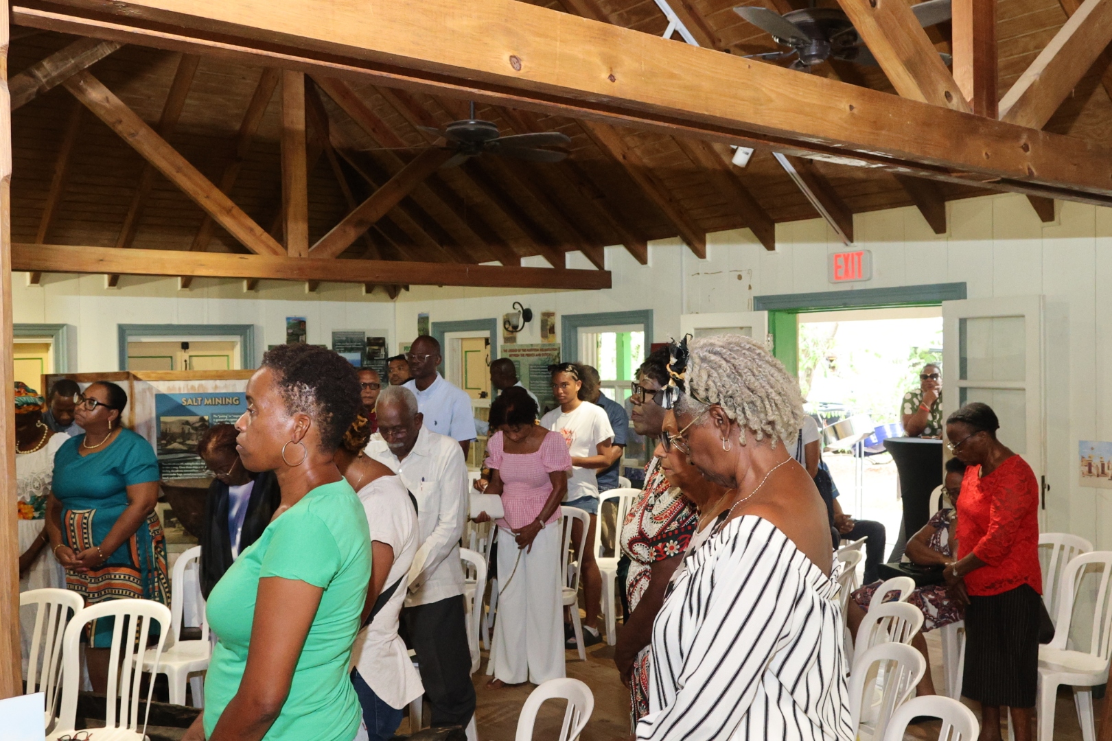 Guests standing reverently for prayer